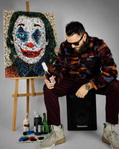 Bottl3man creating a live painting performance inspired by an iconic comic book character during a luxury event.