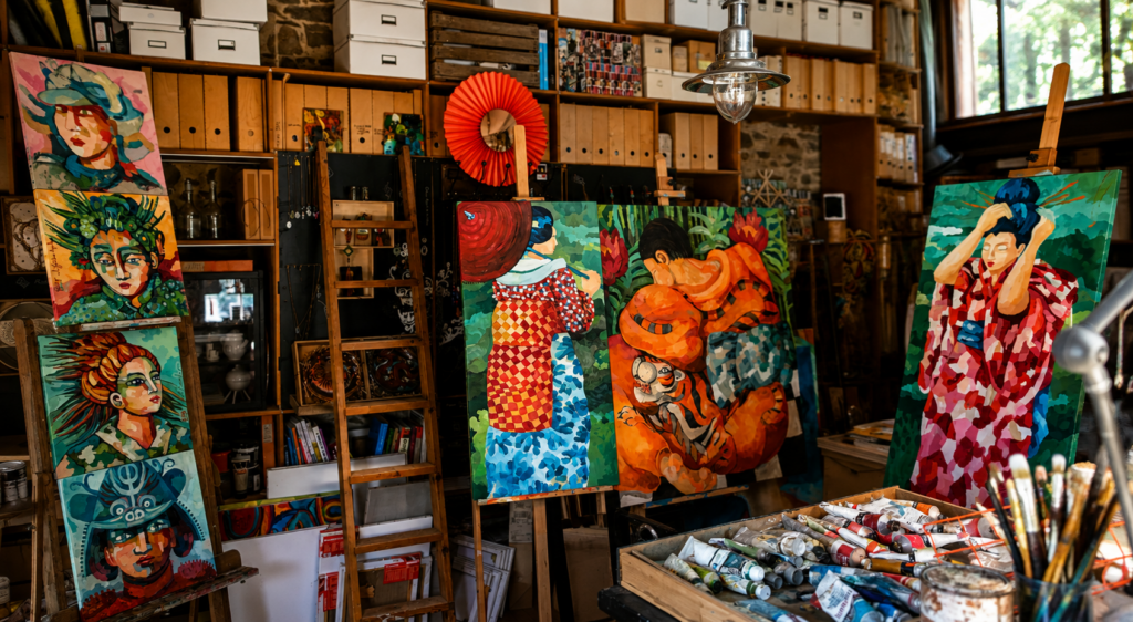 Julie Buffet’s artist studio in France featuring her colourful contemporary figurative paintings, works in progress and painting materials.